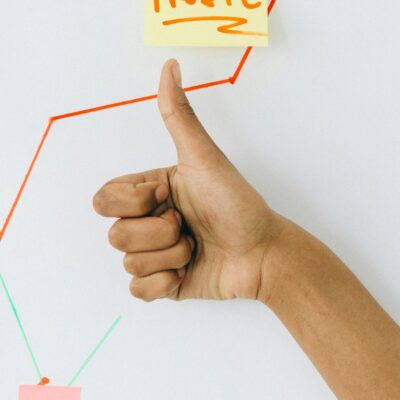 Person Holding Orange and White Paper